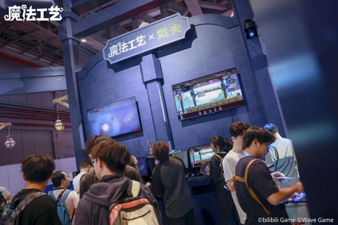 玩家围在试玩区屏幕前观看战斗实况,画面中戴夫使用多重元素法杖对大王鱿鱼发动连击